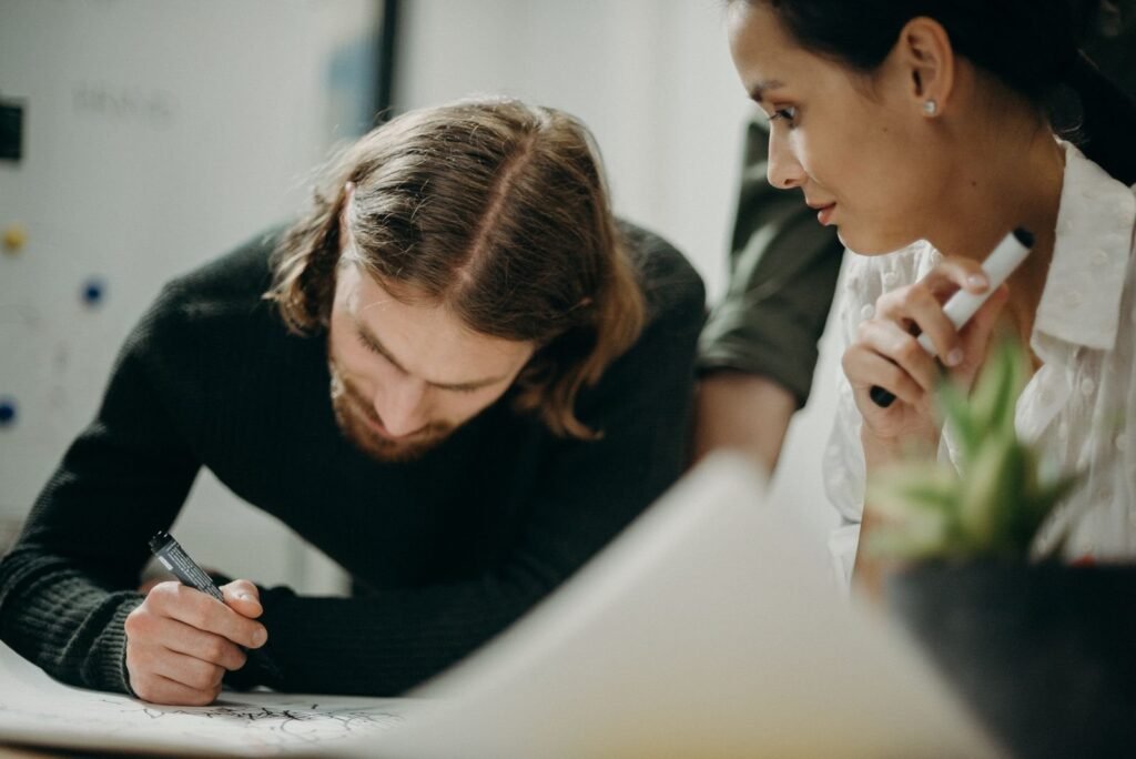 Two colleagues in a strategy meeting planning their marketing approach