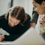 Two colleagues in a strategy meeting planning their marketing approach